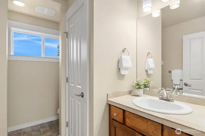 The ADU's 3/4 bath features a clean and functional design with a warm wood vanity and bright lighting — a well-appointed space that completes this fully self-contained and permitted above-garage unit. The ADU's 3/4 bath features a clean and functional design with a warm wood vanity and bright lighting — a well-appointed space that completes this fully self-contained and permitted above-garage unit.