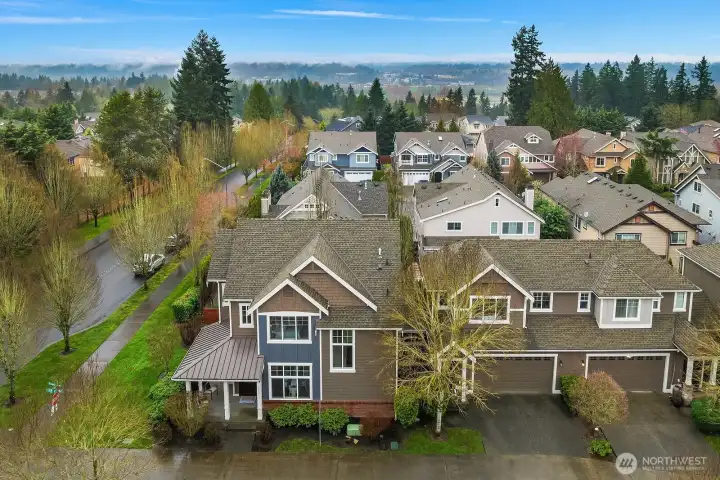 This aerial view showcases the home's desirable corner lot position within the Sycamore Park neighborhood, highlighting the classic Craftsman architecture, private yard, and the well-established, tree-lined community setting. This aerial view showcases the home's desirable corner lot position within the Sycamore Park neighborhood, highlighting the classic Craftsman architecture, private yard, and the well-established, tree-lined community setting.