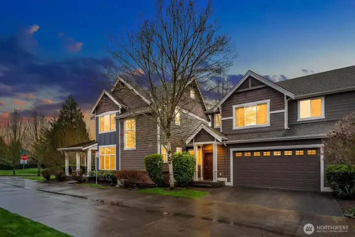 Another stunning evening exterior shot highlights the home's impressive presence on the corner lot, with the warm glow of interior lights, classic Craftsman detailing, and a spacious three-car garage creating an unforgettable first impression. Another stunning evening exterior shot highlights the home's impressive presence on the corner lot, with the warm glow of interior lights, classic Craftsman detailing, and a spacious three-car garage creating an unforgettable first impression.