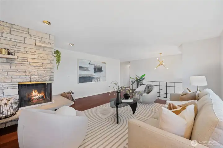 Warm and welcoming, the living room features an iconic stone fireplace and generous space for guests. Warm and welcoming, the living room features an iconic stone fireplace and generous space for guests.
