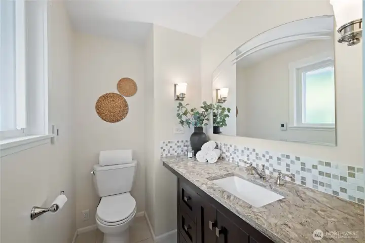 Private primary half bath with updated vanity and radiant-heated floors. Private primary half bath with updated vanity and radiant-heated floors.