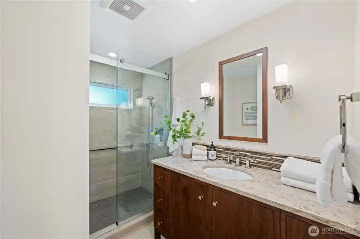 Beautifully updated hallway bathroom featuring a tiled walk-in shower and modern finishes. Beautifully updated hallway bathroom featuring a tiled walk-in shower and modern finishes.