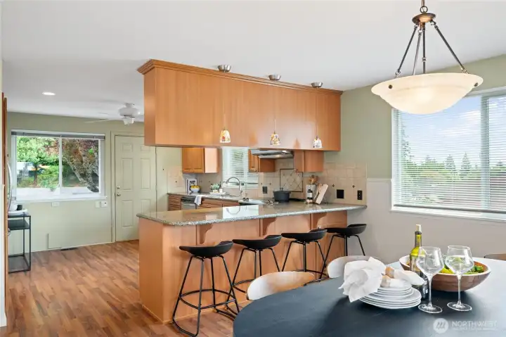 The dining area flows seamlessly into the expansive kitchen, creating the perfect gathering space. The dining area flows seamlessly into the expansive kitchen, creating the perfect gathering space.