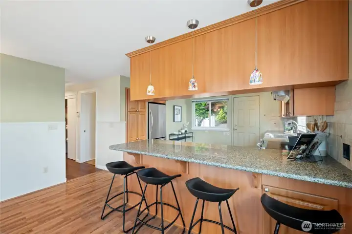 A breakfast bar offers generous seating for casual dining and conversation. A breakfast bar offers generous seating for casual dining and conversation.