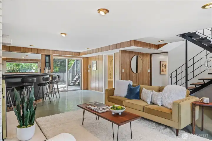 Comfortable lower-level gathering space flows effortlessly to the wet bar and secluded patio. Comfortable lower-level gathering space flows effortlessly to the wet bar and secluded patio.