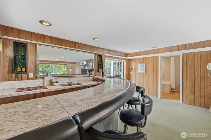 Classic retro wet bar with generous seating celebrates the home's original mid-century design. Classic retro wet bar with generous seating celebrates the home's original mid-century design.
