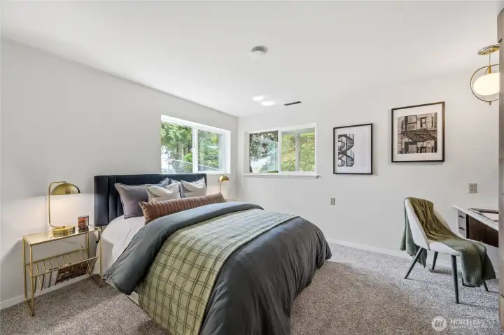 Bright lower-level bedroom features corner windows, new carpet, and a private peaceful setting. Bright lower-level bedroom features corner windows, new carpet, and a private peaceful setting.