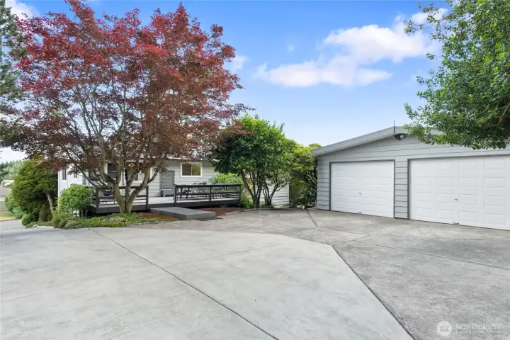 Private rear approach showcases the detached garage, entertaining deck, and abundant off-street parking. Private rear approach showcases the detached garage, entertaining deck, and abundant off-street parking.