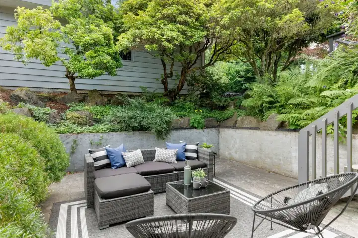 Surrounded by mature gardens, this secluded patio offers a tranquil setting to relax or entertain. Surrounded by mature gardens, this secluded patio offers a tranquil setting to relax or entertain.