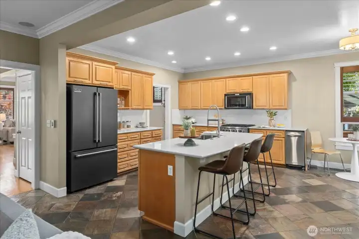 Spacious kitchen with luxury appliances, plenty of cabinet and prep space, and informal seating Spacious kitchen with luxury appliances, plenty of cabinet and prep space, and informal seating