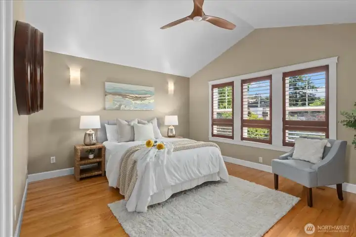 Primary bedroom with vaulted ceilings,wall of windows, and ceiling fan to keep you cool in summer Primary bedroom with vaulted ceilings,wall of windows, and ceiling fan to keep you cool in summer