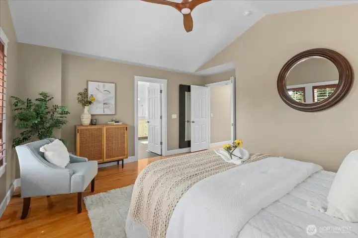 Primary bedroom with vaulted ceilings,wall of windows, and ceiling fan to keep you cool in summer Primary bedroom with vaulted ceilings,wall of windows, and ceiling fan to keep you cool in summer