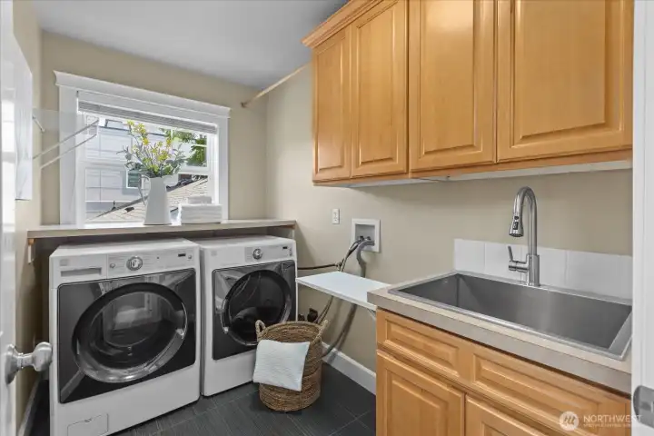 Upstairs laundry room with cabinets and sink Upstairs laundry room with cabinets and sink