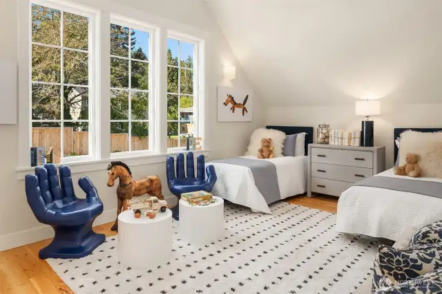 The second of two upstairs vaulted ceiling bedrooms is filled with light from its westerly exposure.