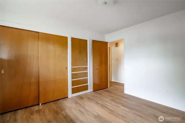 Bedroom 2 with newer vinyl flooring and built in cabinet.