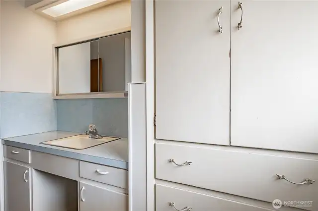 Hall bathroom with extra cabinets for storage.