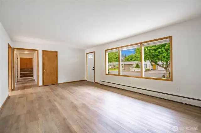 Large living room with newer vinyl flooring.