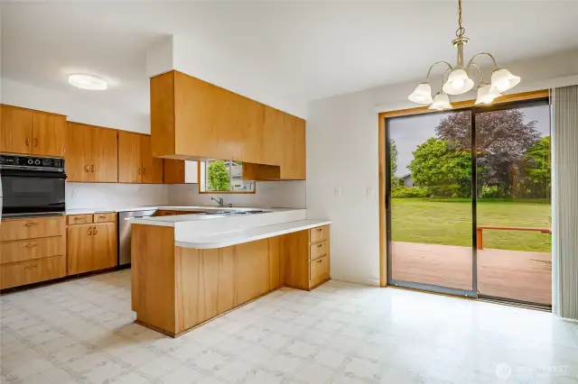 Kitchen with plenty of cabinets, eating bar and dining room looking out to big backyard!