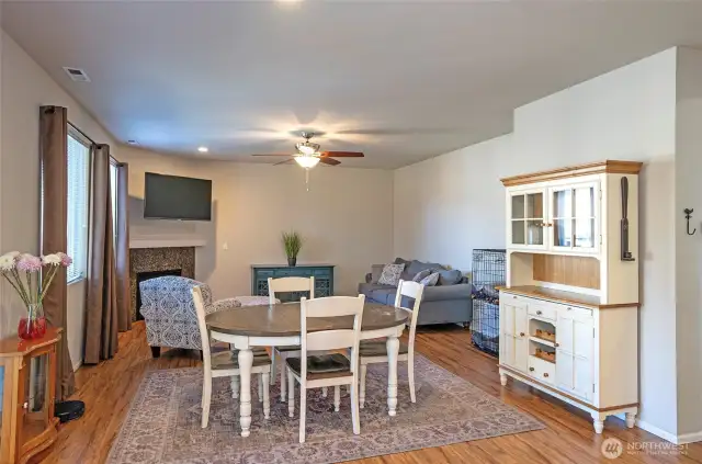 Another view of the dining and family room areas, where the ceiling fan adds a touch of comfort and airflow to the open space.