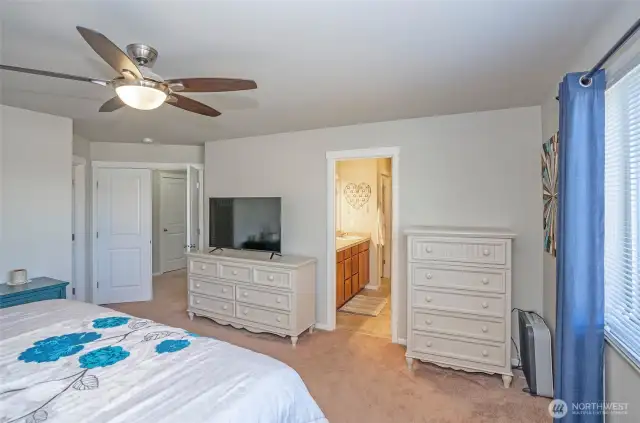 This angle highlights the primary suite’s elegant double-door entry and attached private ensuite.