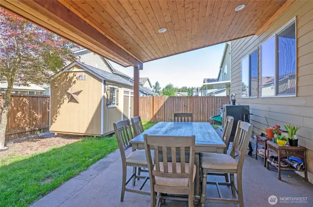 Enjoy this additional perspective of the covered patio and the convenient storage shed, offering extra room for your belongings.