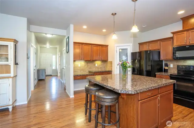 From the kitchen, enjoy a line of sight down to the welcoming front entry.