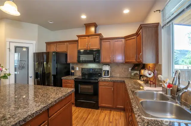 A spacious walk-in pantry complements this beautifully updated kitchen, offering all the storage and prep space you need for effortless meal preparation.