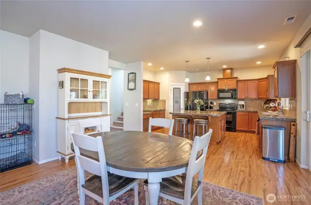 The family room offers a great view into the dining and kitchen areas, creating an open, connected space perfect for entertaining guests. Beautiful laminate flooring flows throughout the entire main level, adding warmth and style.