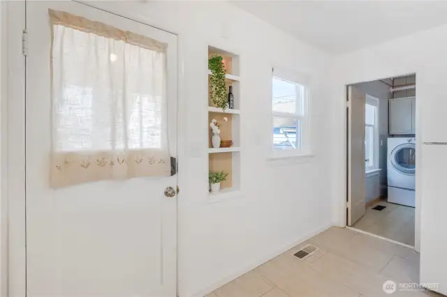 Back door entry into covered porch that leads to deck.