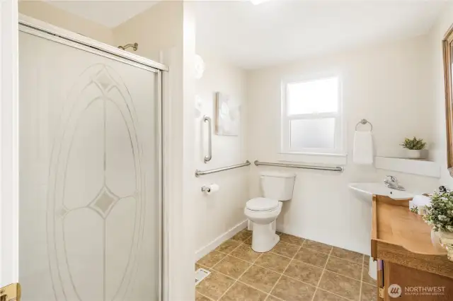 Large bathroom with accessible toilet features.