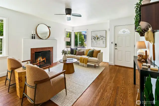 Fireplace anchors the space; great windows overlooking trees.