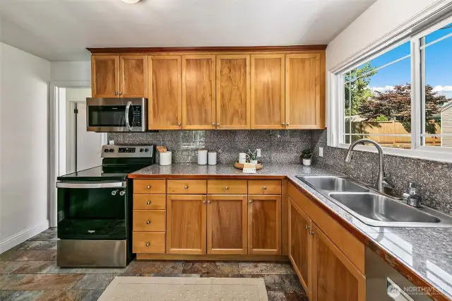 Kitchen sink window overlooks the backyard.