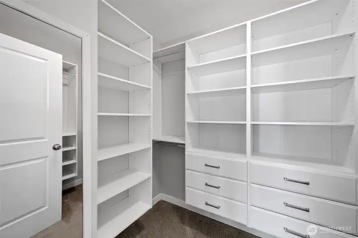 Custom designed walk-in closet in the primary