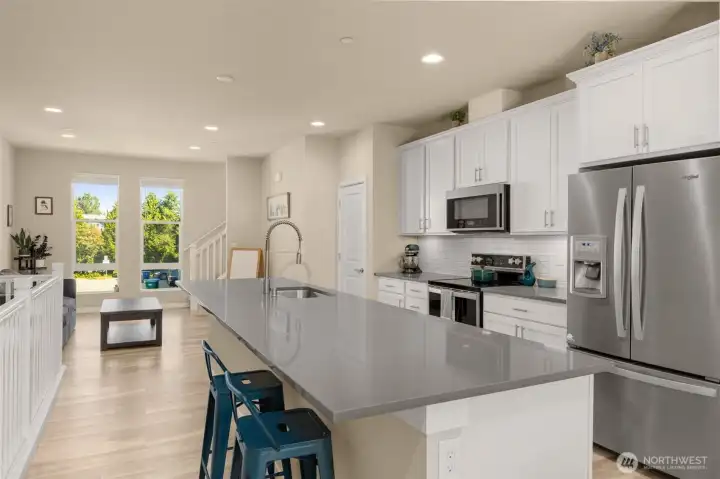 Designed for both function and style, the open-concept main level boasts quartz countertops and generous storage throughout, including a walk-in pantry you’ll love!