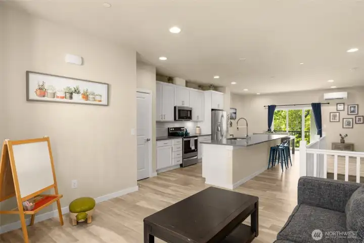 The main-level living room sits just beyond the kitchen—ideal for keeping the conversation going while cooking or hosting. It's larger than it appears!