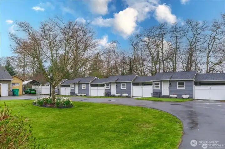 1.31 level acres with a 2400sf craftsman home PLUS 6 fully rented tiny homes!