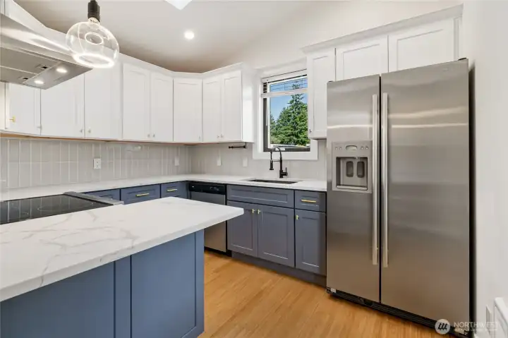 Brand new kitchen with two tone cabinets, gold hardware, S.S. Applicances and Quartz Countertops