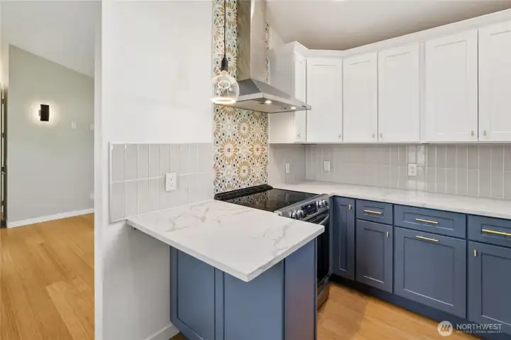 Vaulted Ceilings extend into the kitchen area.  Tile backsplash all the way around