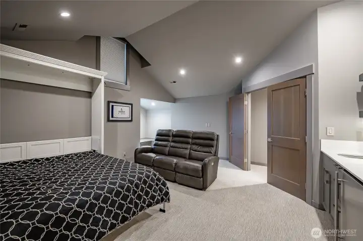 Upstairs Bedroom with ensuite, murphy bed, tv area with mini bar for your guests.