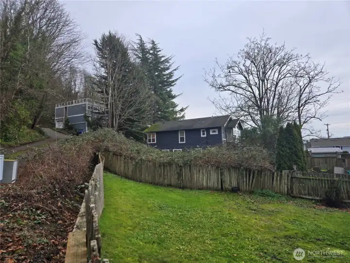 lot is between the fence and the blue house