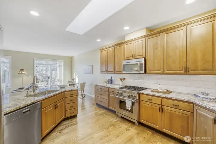 Kitchen with Wolf range, JennAir refrigerator and a Miele dishwasher