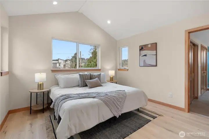 Gorgeous primary suite with vaulted ceiling and territorial views.