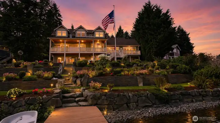 This 3+bedroom, 3.5-bath waterfront home on Long Lake in Lacey offers 4,787 square feet, 105 feet of no-wake shoreline, and a daylight basement with separate entrance and second kitchen for multi-generational living or guest use. Built in 1997 and updated through 2025, the layout includes a flex room, three fireplaces, and a 3-bay garage with RV parking on a 0.548-acre lot. The main level features a chef’s kitchen with quartz and granite surfaces, including an AGA cookstove, connected to open living and dining areas with lake views. The primary suite includes a gas fireplace and a remodeled 2025 bathroom with heated floors and soaking tub. The lower level includes a private entrance, full second kitchen, and separate living space for flexible use. System improvements include geothermal HVAC, central A/C, and wired generator capability.