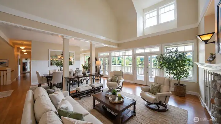 Built in 1997 and updated through 2025, the layout includes a flex room, three fireplaces, and a 3-bay garage with RV parking on a 0.548-acre lot. The main level features a chef’s kitchen with quartz and granite surfaces, including an AGA cookstove, connected to open living and dining areas with lake views. The primary suite includes a gas fireplace and a remodeled 2025 bathroom with heated floors and soaking tub. The lower level includes a private entrance, full second kitchen, and separate living space for flexible use. System improvements include geothermal HVAC, central A/C, and wired generator capability.