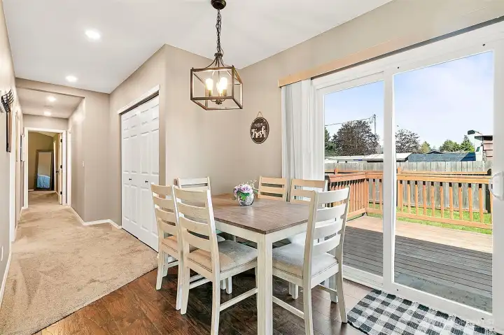 Backyard access through the dining area, laundry area nestled centrally in the hallway.