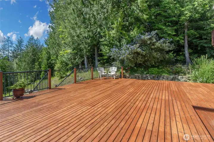 Entertainment sized deck with stairs down to hot tub/spa.