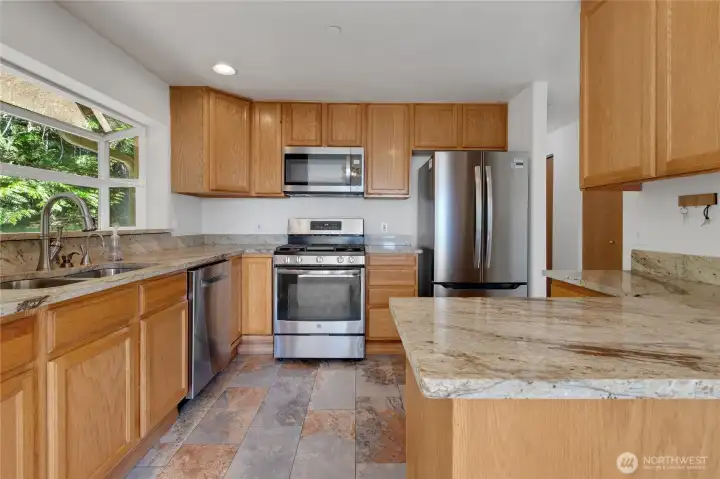 Beautiful kitchen with granite and stainless appliances.
