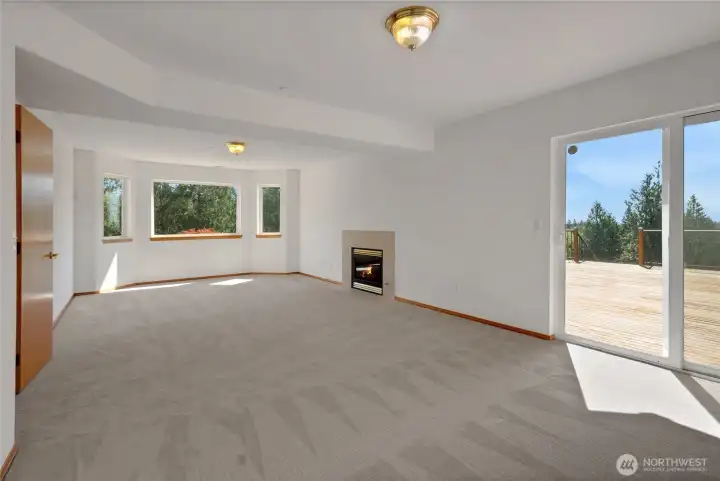 Daylight basement great room with gas fireplace and deck access.
