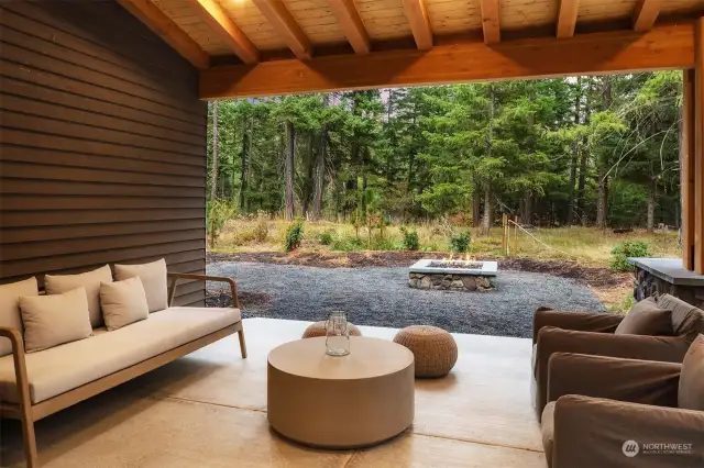 Covered patio space entices year-round enjoyment—imagine sipping morning coffee while taking in fresh, mountain air—with extended patio and firepit for added fun.