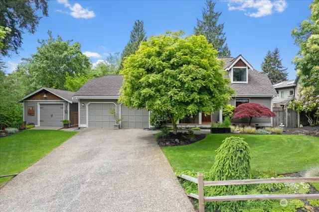 Welcome home to your perfectly manicured East facing home.  Primary ensuite on the main, private backyard with views of the creek and rare shop.